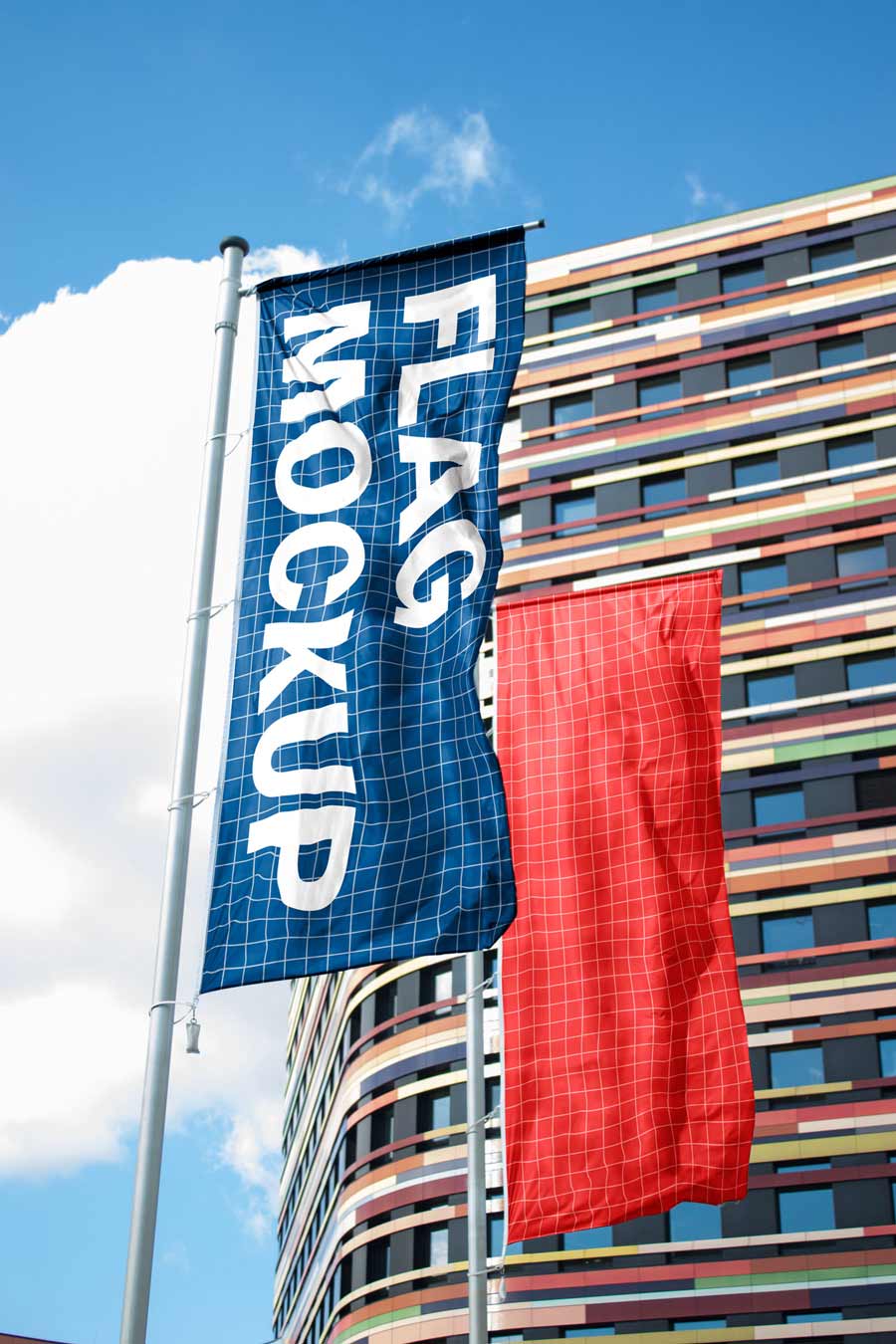 free flag mockup with two vertical flags in front of blue sky