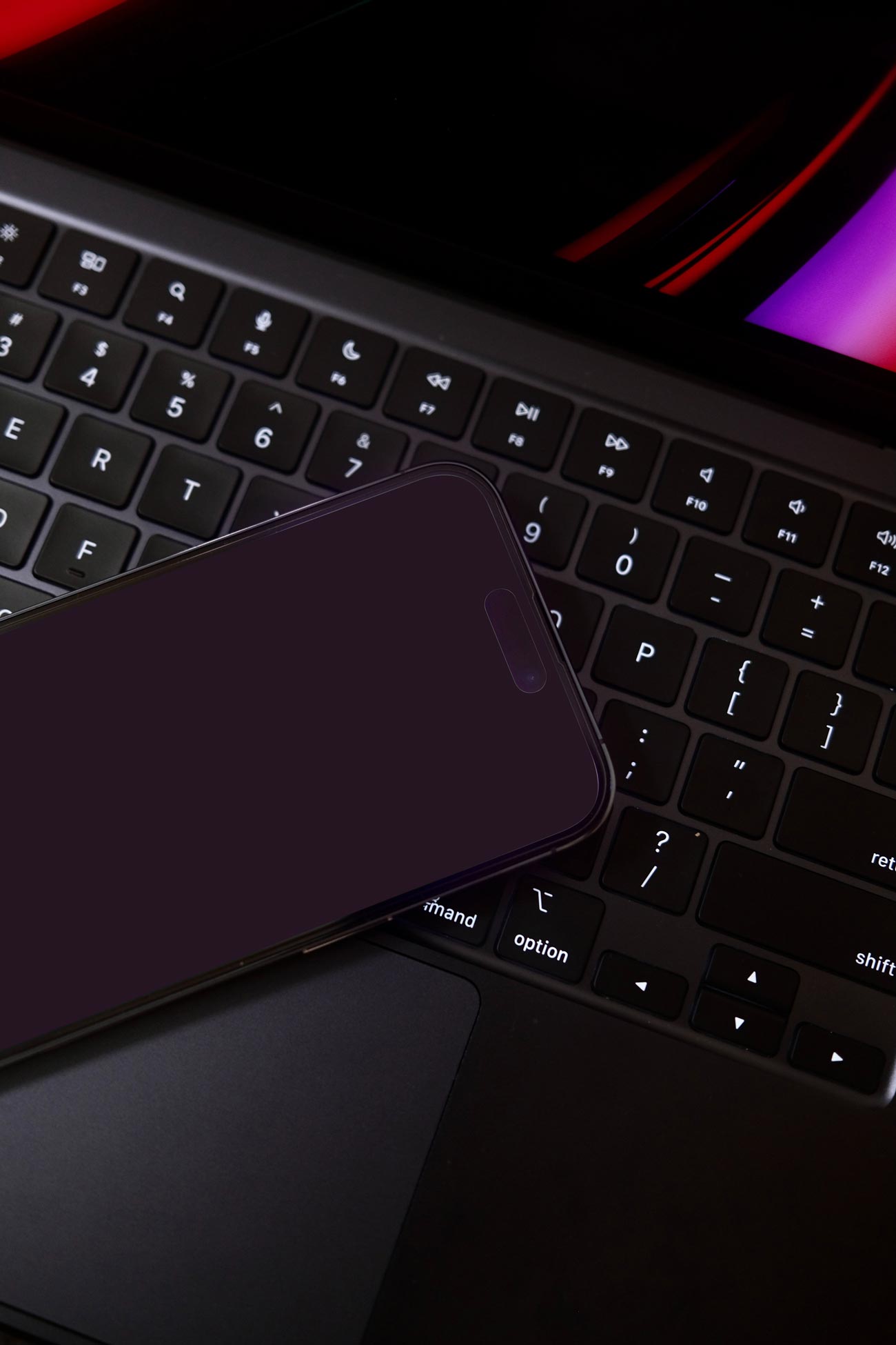 free iphone 14 screen mockup on dark background with macbook