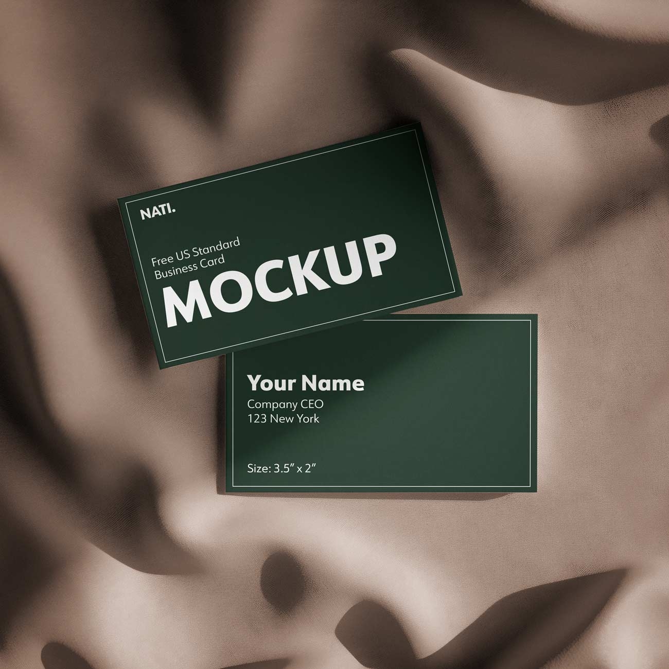free mockup of a green double sided business card (standard US size) lying on a beige cloth background